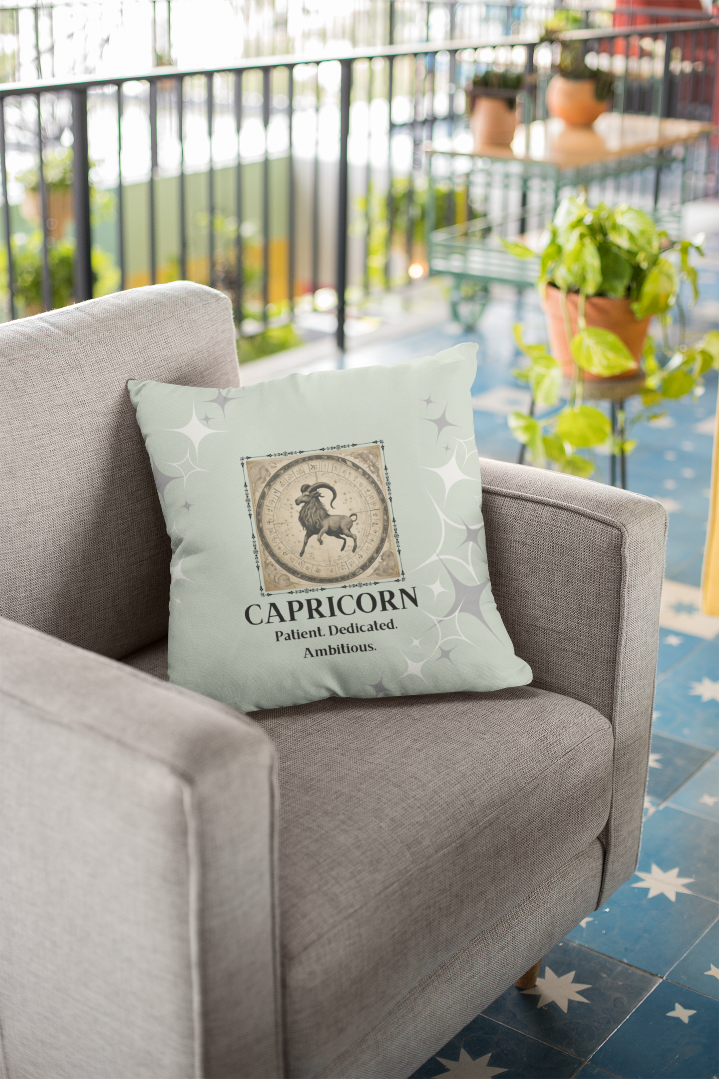 Mint Capricorn pillow on khaki colored couch.