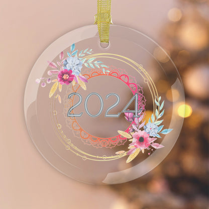 Style 1 Glass year ornament hanging in front of pink Christmas background.