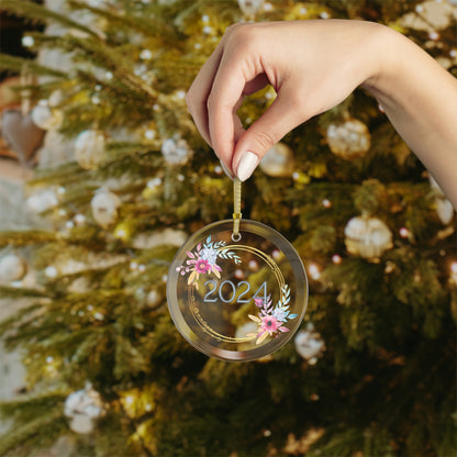 Hand holding Style 1 Commemorative Year Ornament in front of Christmas tree.