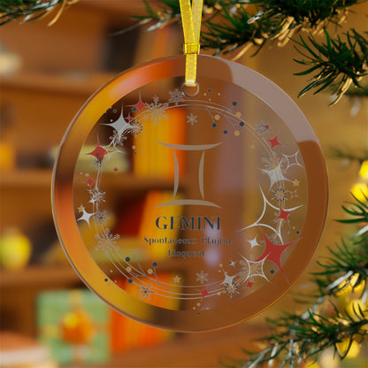 Glass zodiac ornament in Gemini hanging on Christmas tree.