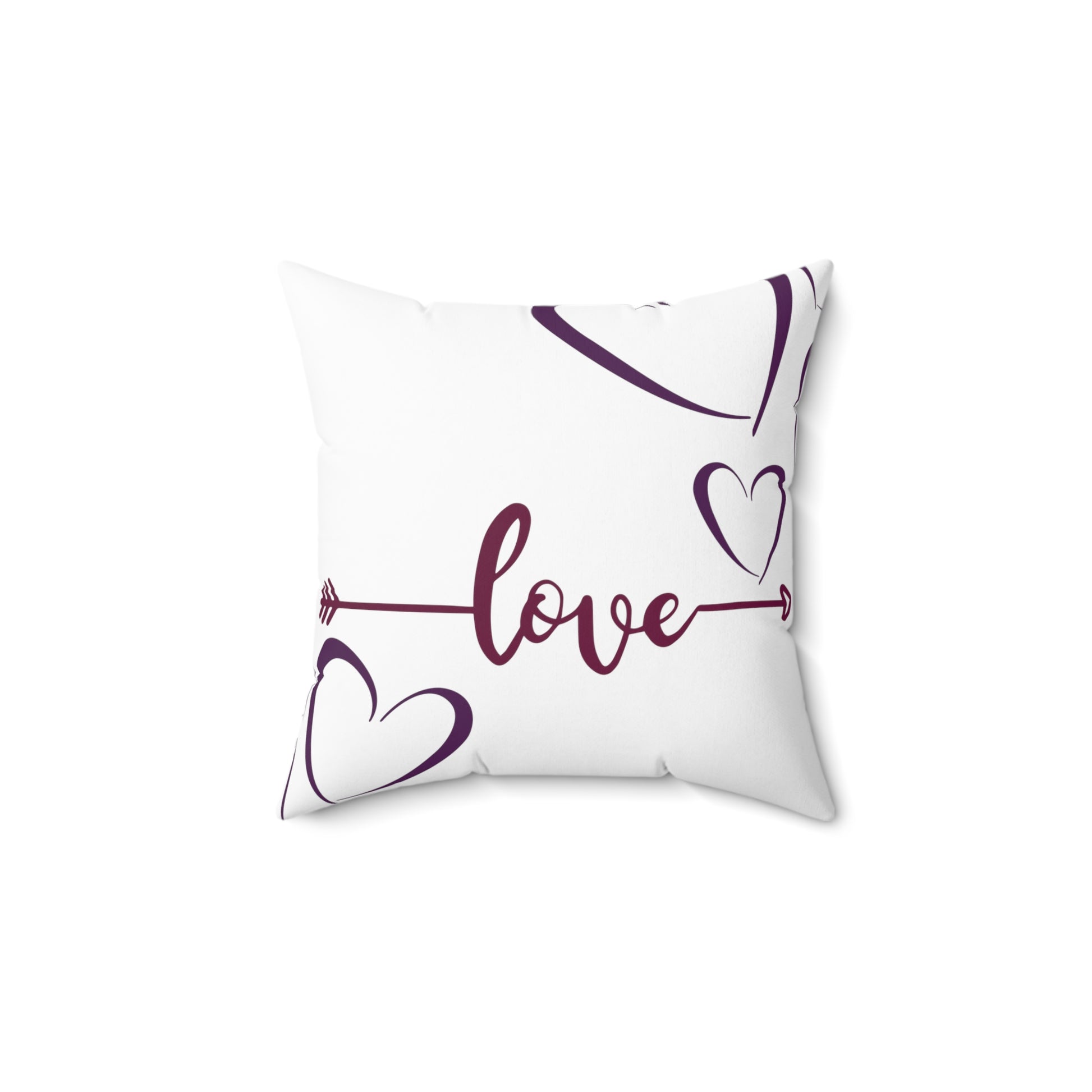 White love pillow featuring cupids arrows with “love” written in middle.