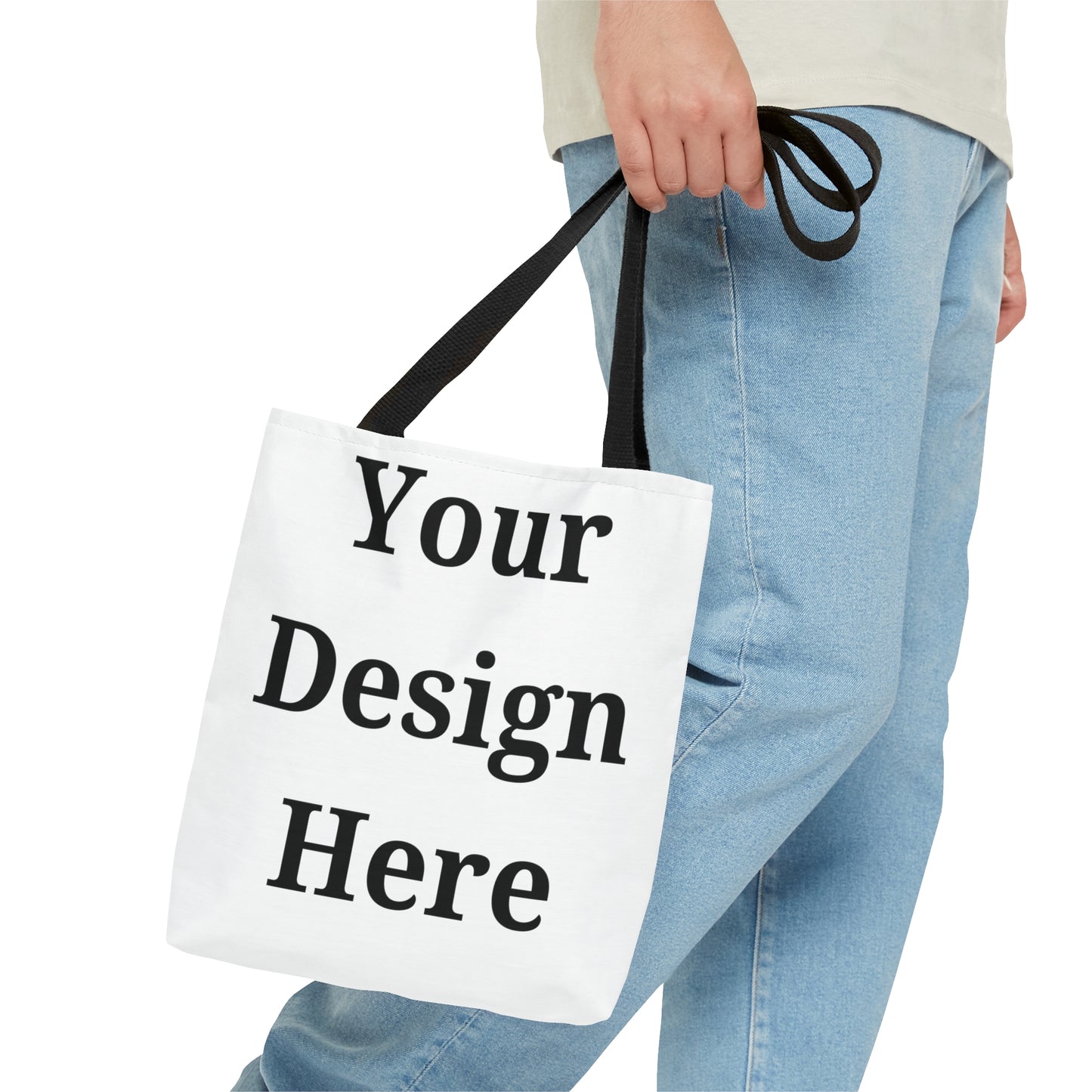 Person carrying small tote bag featuring “your design here”.