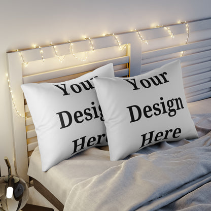 Two pillow cases on bed featuring “your design here”.