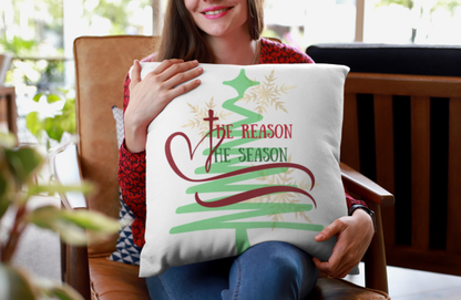 Girl holding White “The Reason” throw pillow while sitting in chair.