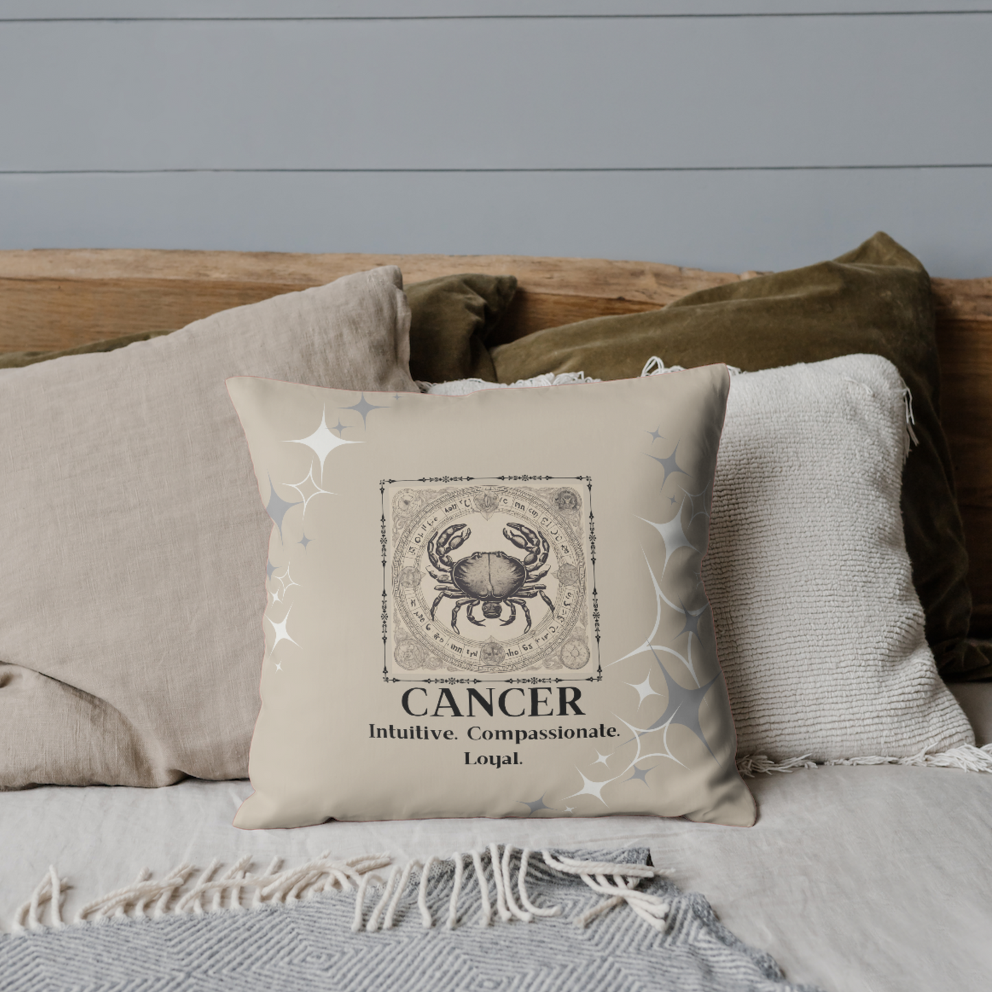 Zodiac throw pillow on bed in Cream.