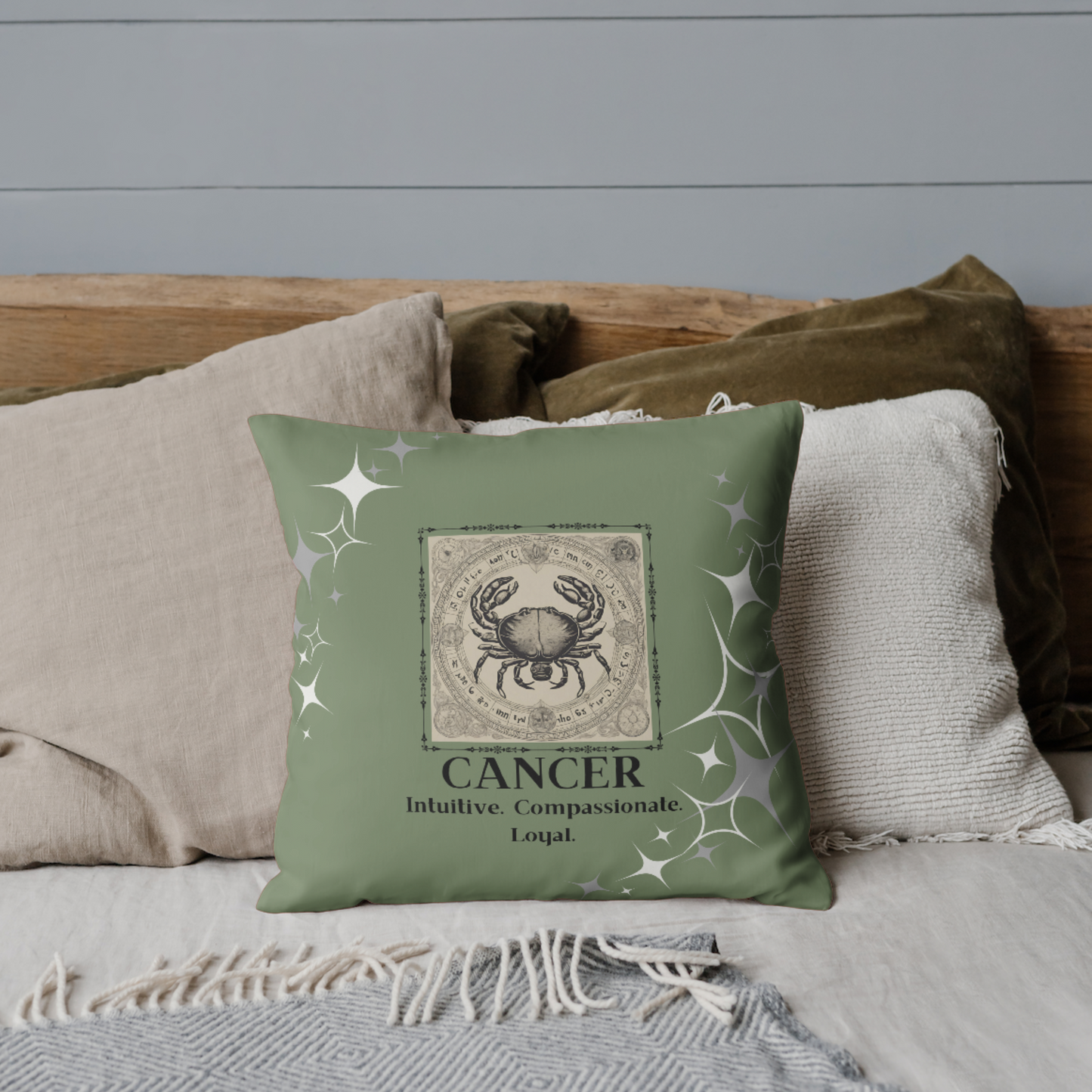 Zodiac throw pillow on bed in Olive.