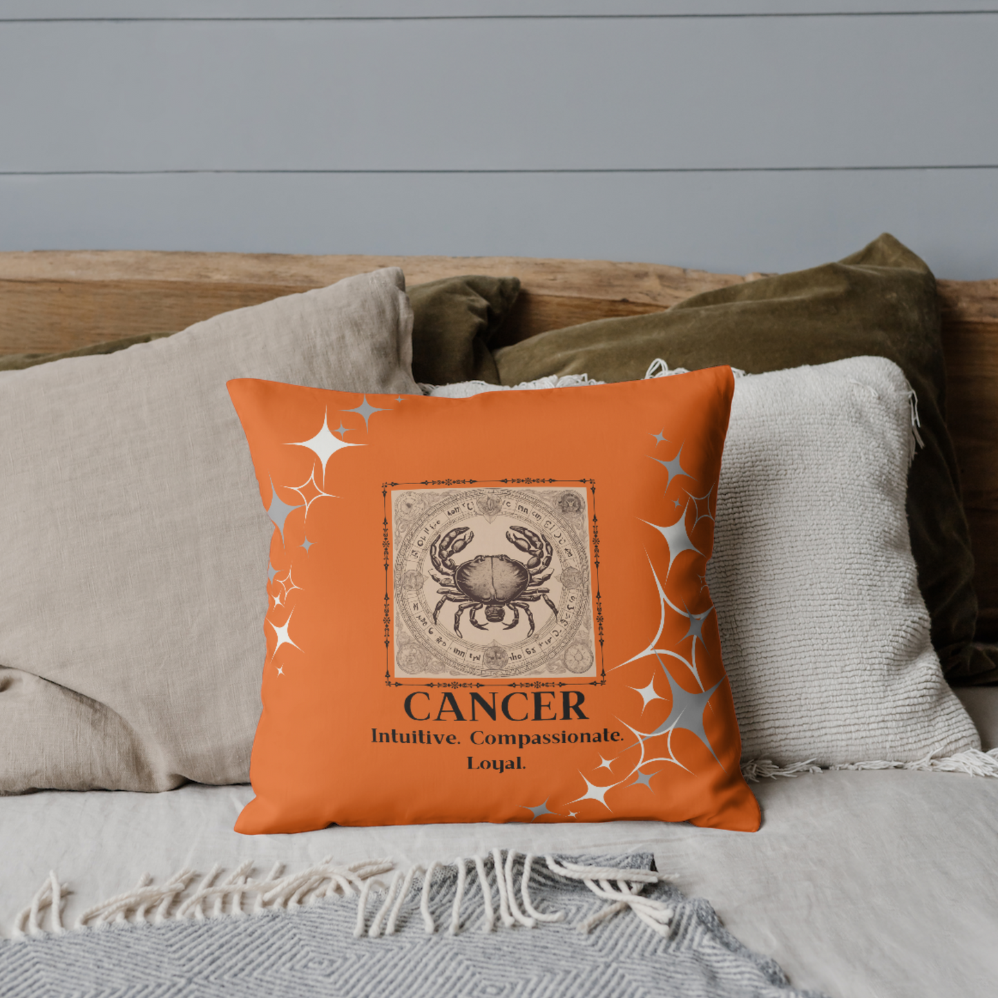 Zodiac throw pillow on bed in Orange Blossom.