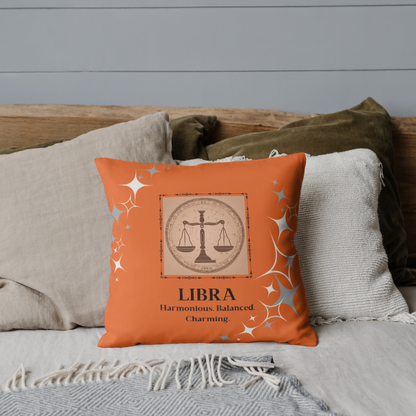 Libra Zodiac Throw Pillow on bed in Orange Blossom.