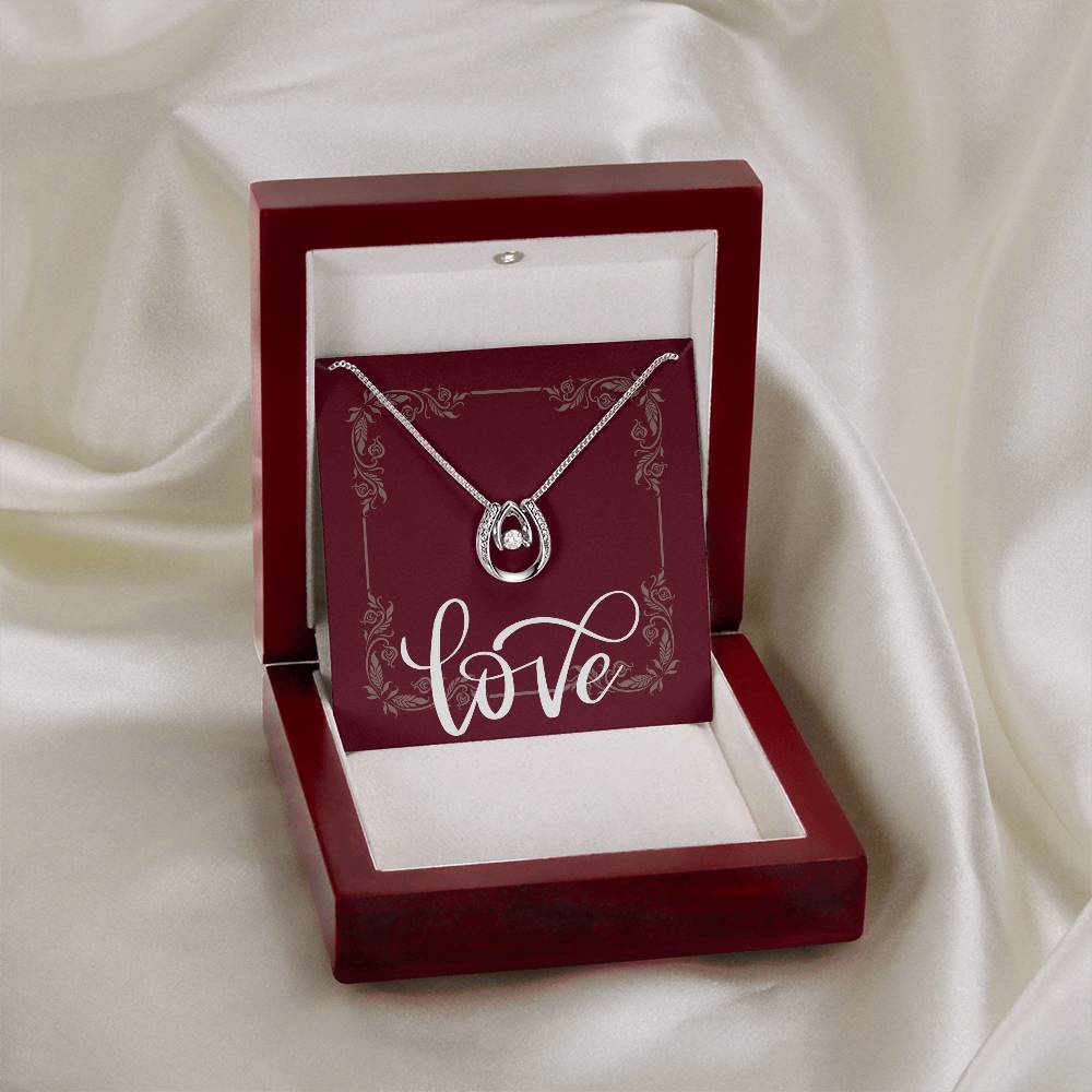 Mahogany jewelry box with “Lucky in Love” necklace displayed.