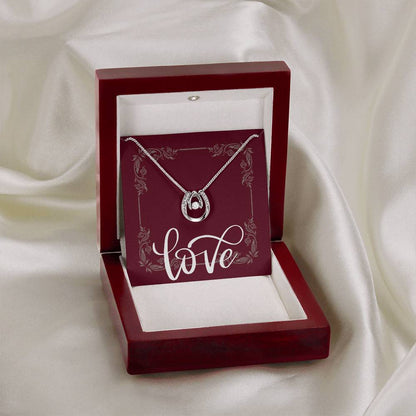 Mahogany jewelry box with “Lucky in Love” necklace displayed.