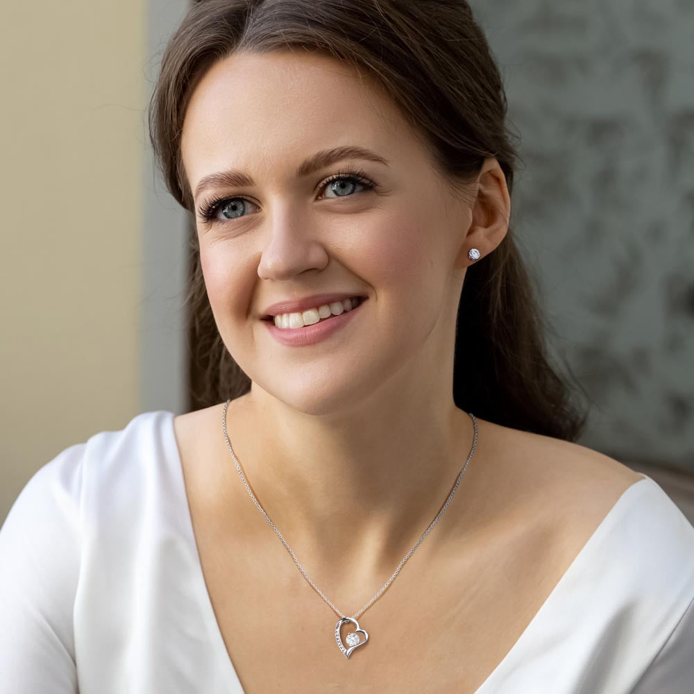 Woman wearing silver heart and earring set