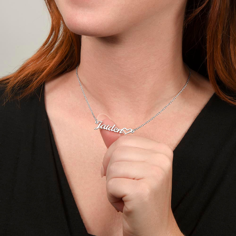 Woman holding silver personalized name necklace on display