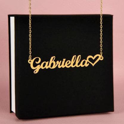 Gold personalized name necklace displayed in front of standard black jewelry box.