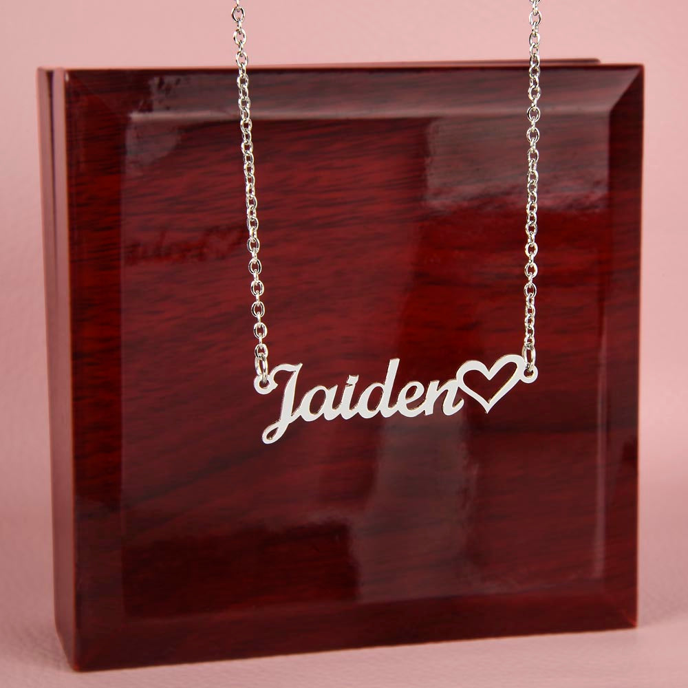 Silver personalized name necklace featuring the name Jaiden with heart accent in front of LED Mahogany box