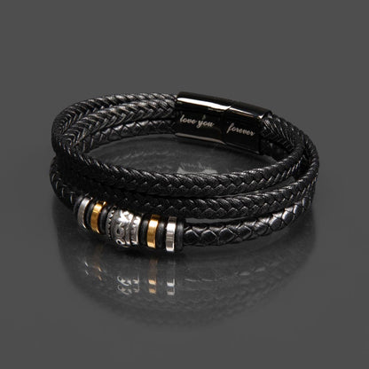 Men’s Love Knot bracelet laying on grey countertop.