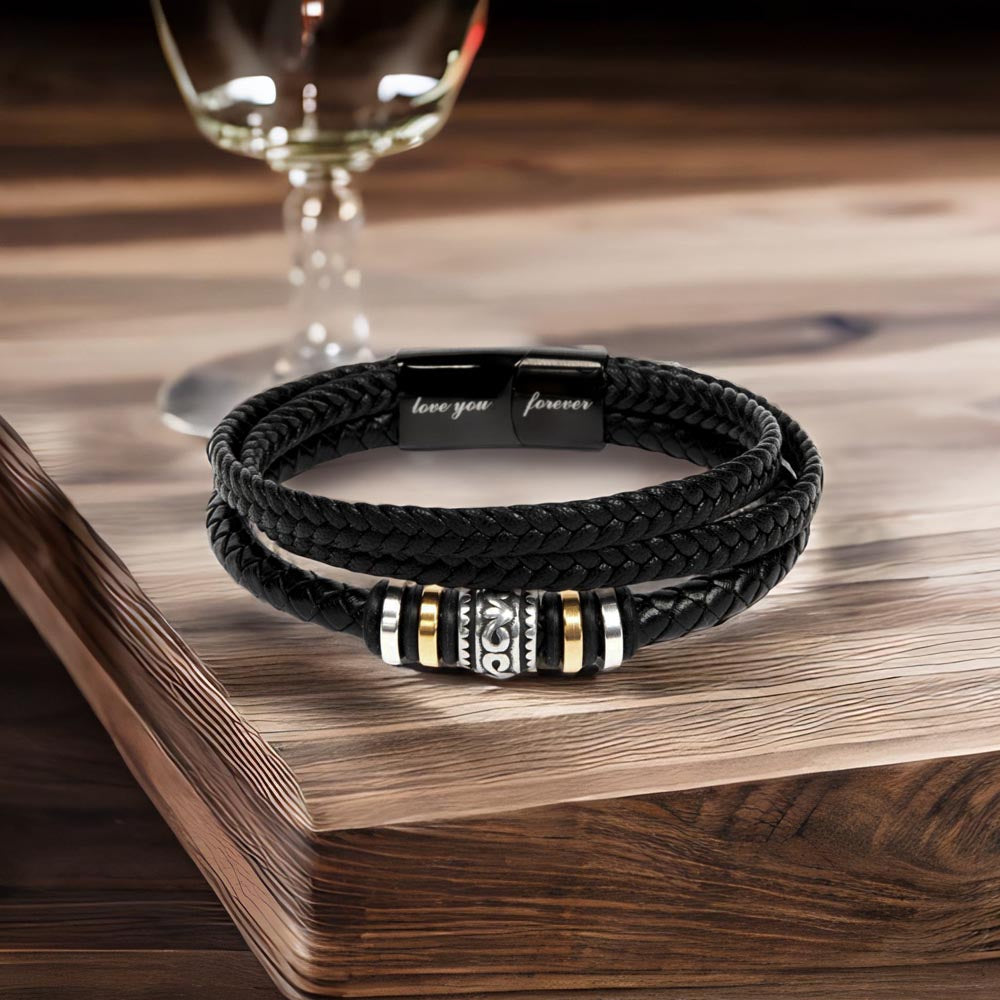 Men’s Love Knot bracelet displayed on table in front of wine glass.