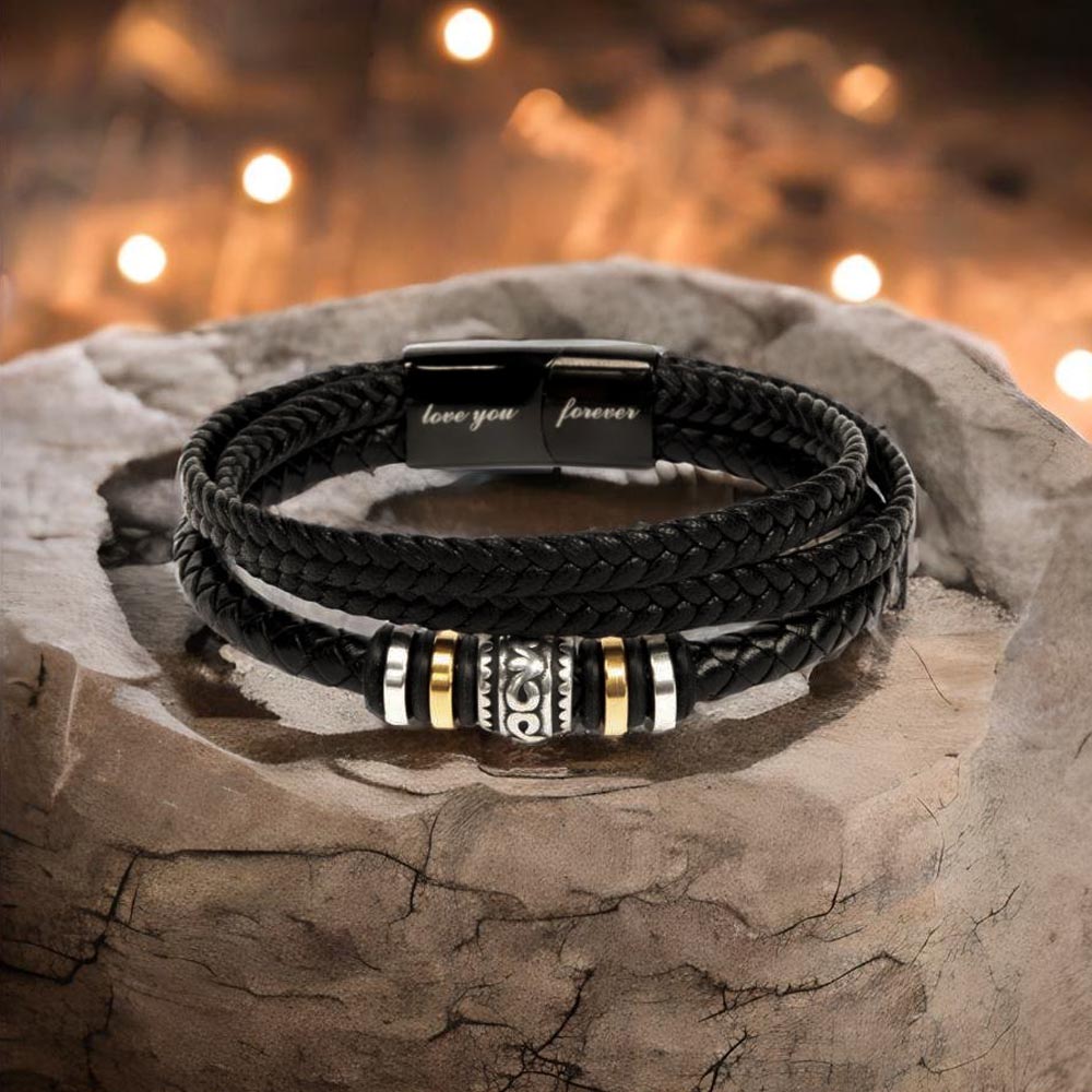 Black vegan leather bracelet with beads displayed on rock.