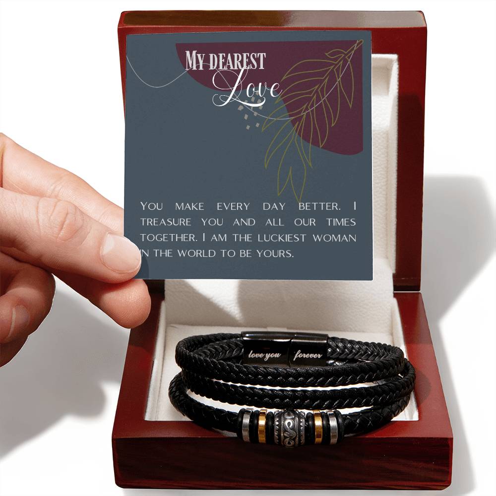 Hand holding message card over Love Knot bracelet inside mahogany box.