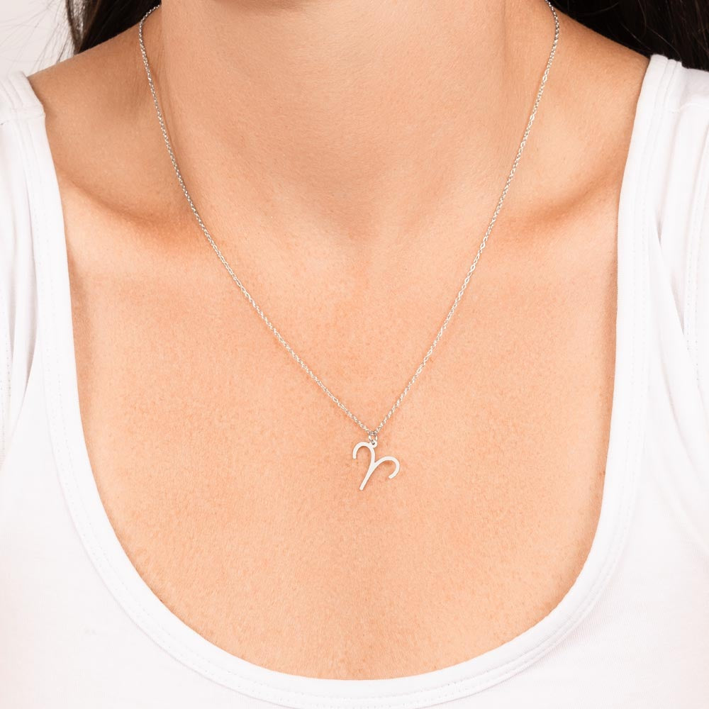 Woman wearing stainless steel zodiac charm necklace.