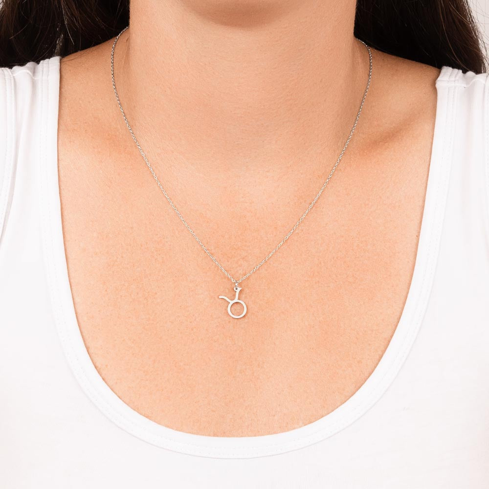 Woman wearing stainless steel zodiac charm necklace.