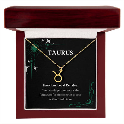 Gold Zodiac charm necklace in elegant mahogany box, showcasing intricate astrological designs.