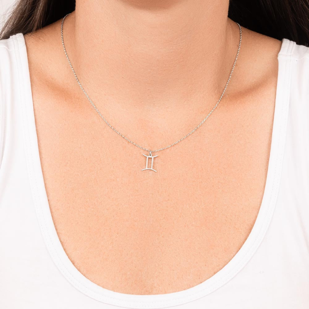 Woman wearing stainless steel zodiac charm necklace.