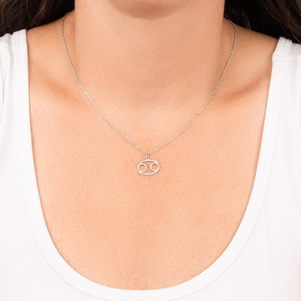 Woman wearing stainless steel zodiac charm necklace.