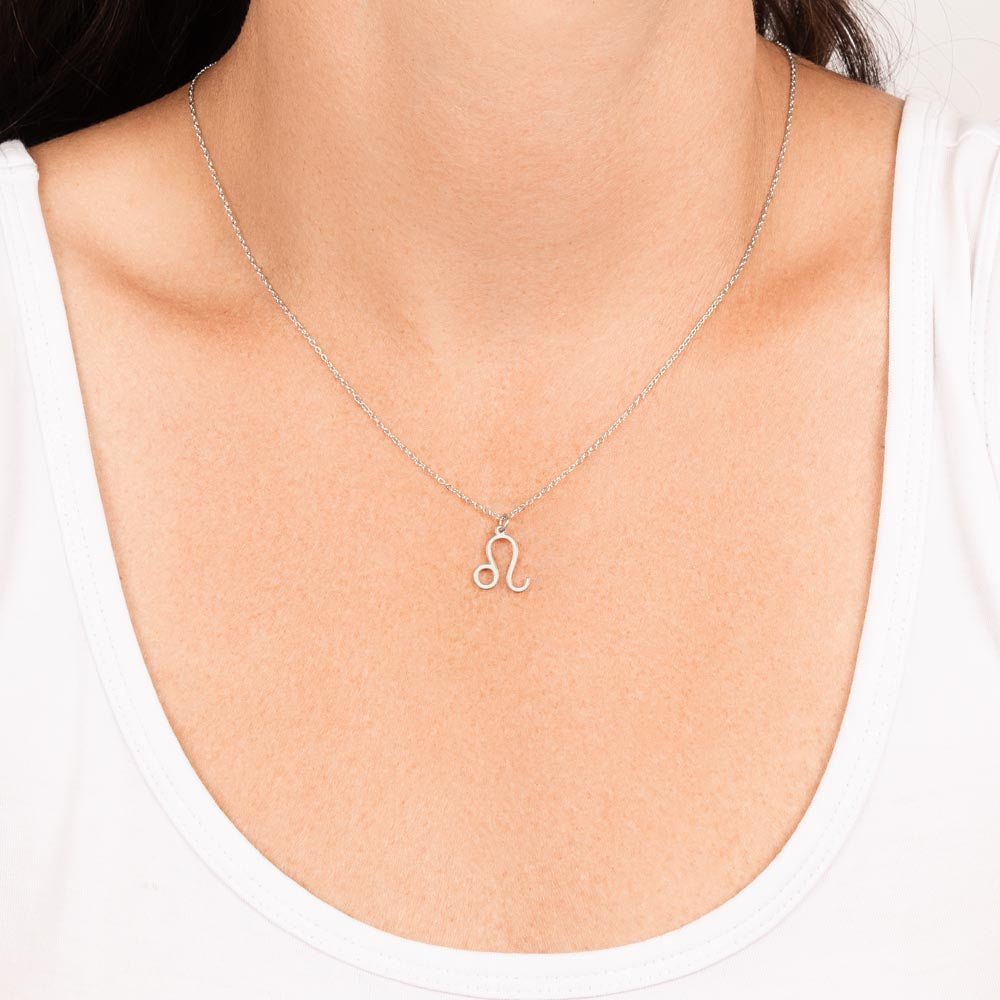 Woman wearing stainless steel zodiac charm necklace.