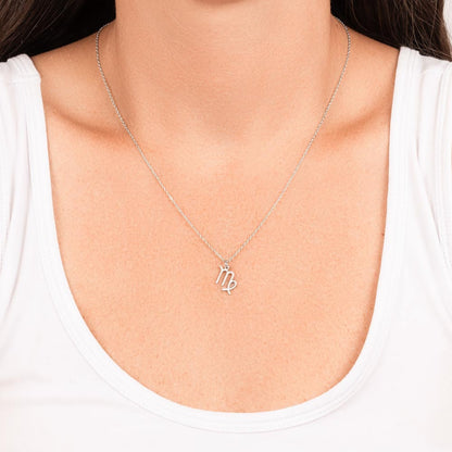 Stainless Steel Virgo Zodiac charm necklace hanging around a woman’s neck.