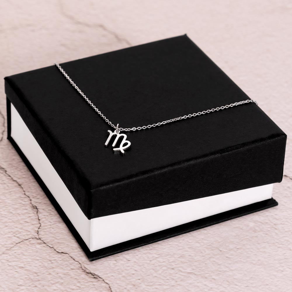 Stainless Steel Zodiac charm necklace laying on elegant black box.