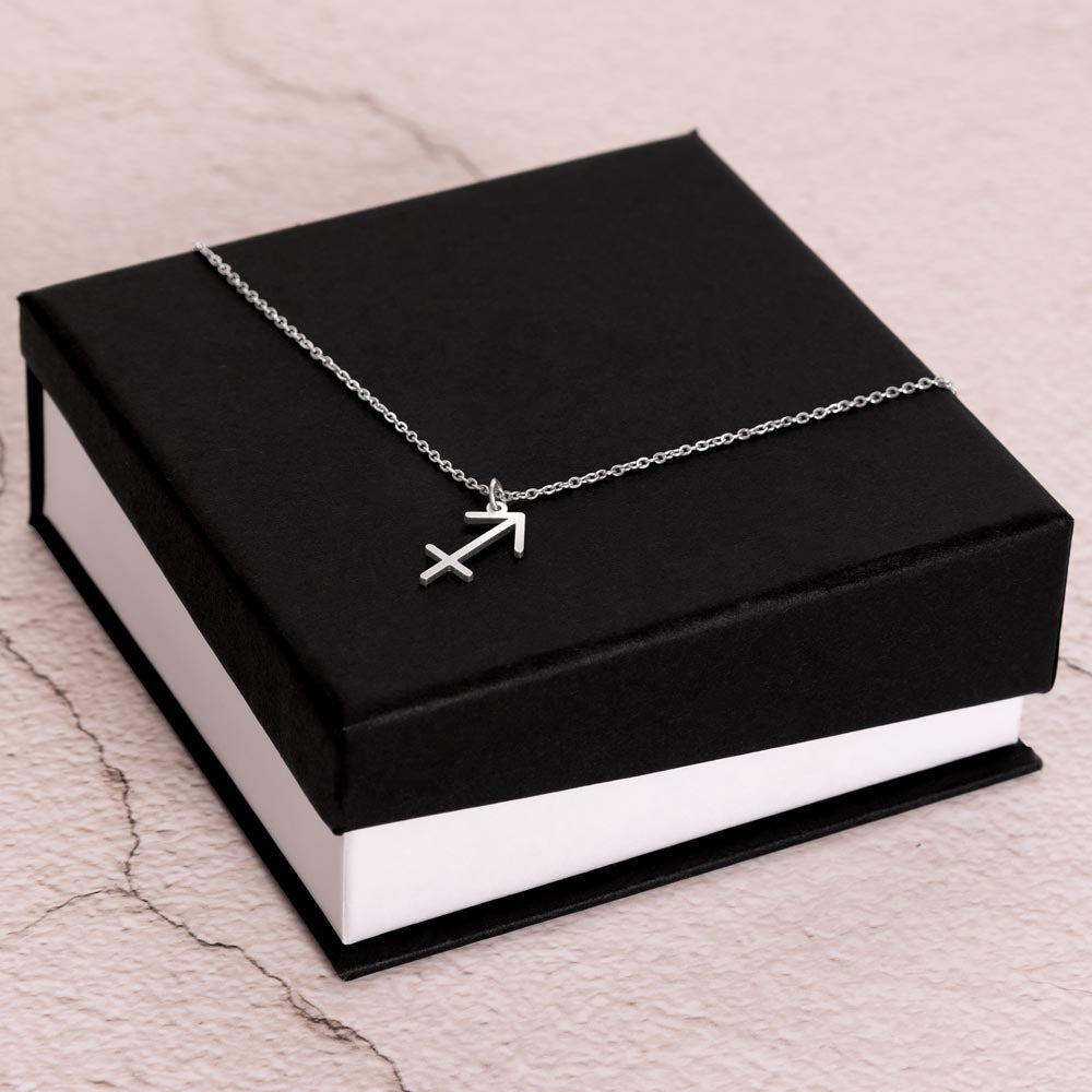 Stainless Steel Zodiac charm necklace laying on elegant black box.