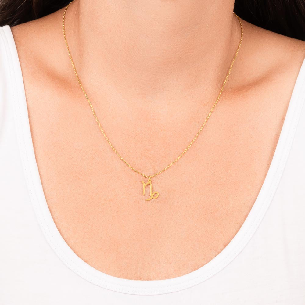 Woman wearing stainless steel zodiac charm necklace.