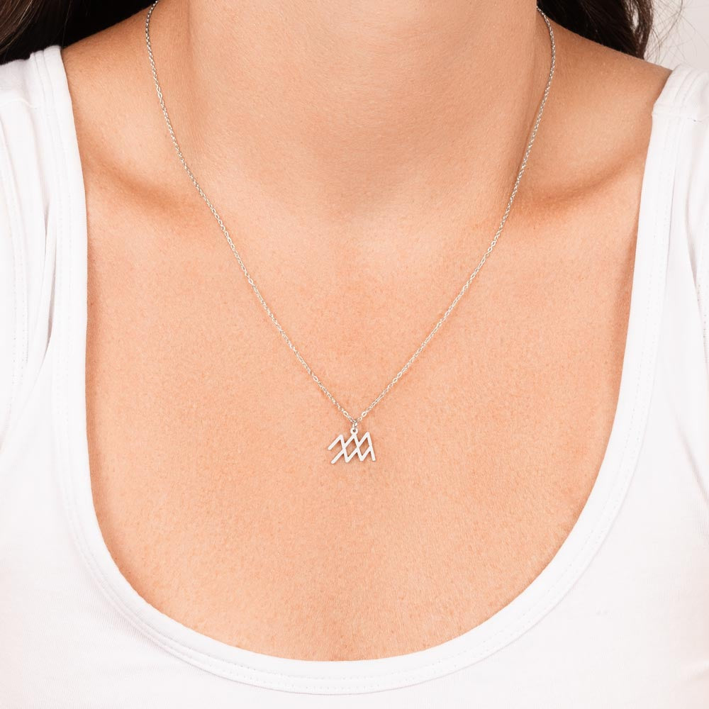 Woman wearing stainless steel zodiac charm necklace.