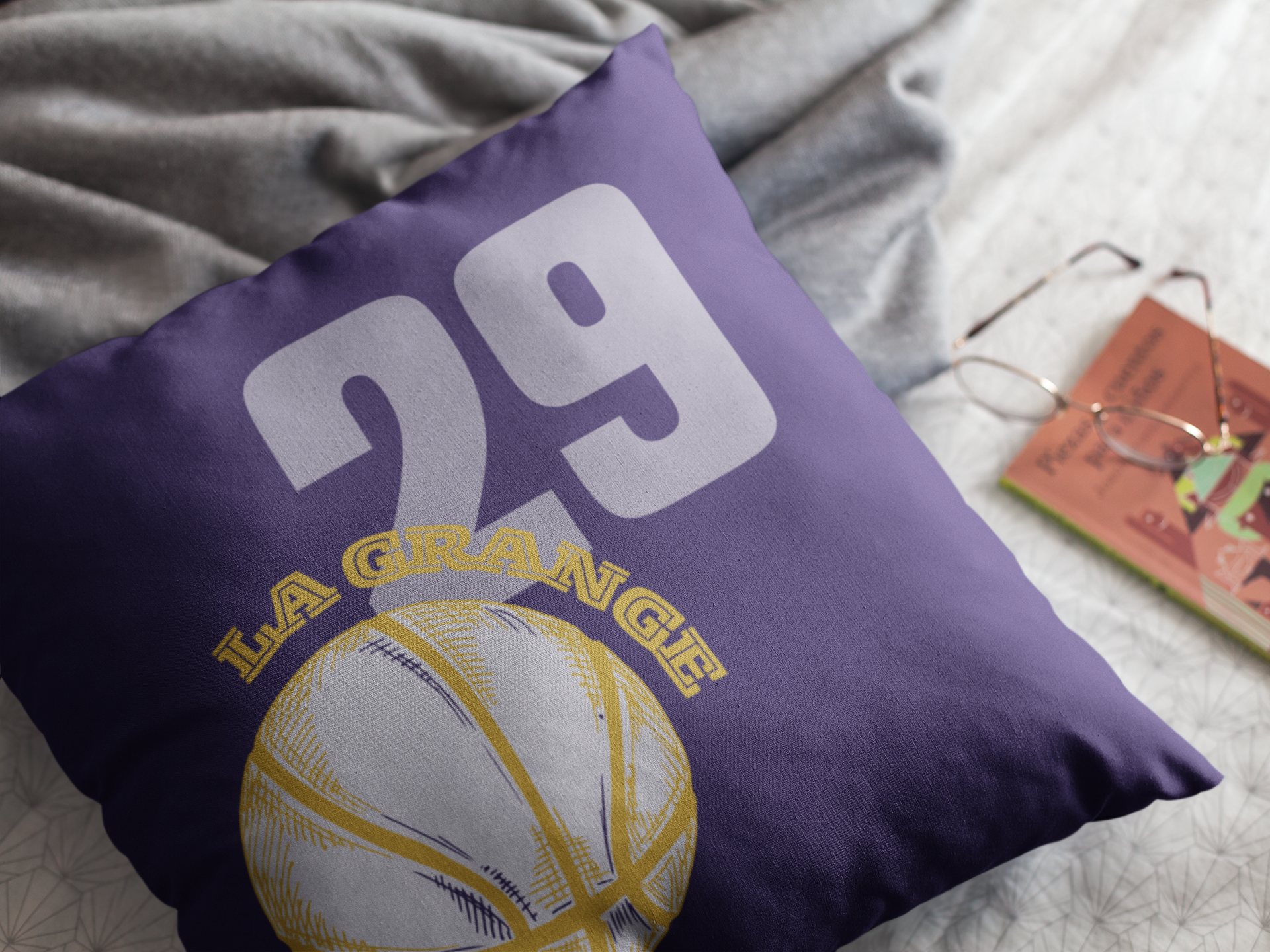 Purple Basketball throw pillow on bed.