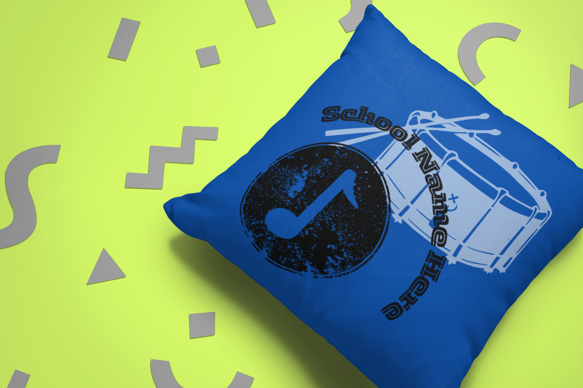 Front of blue school band throw pillow on green background.