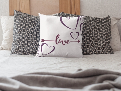 White love arrow pillow on bed as accent decor.