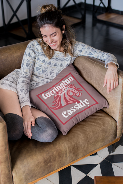 Woman sitting in chair with cheerleader throw pillow.