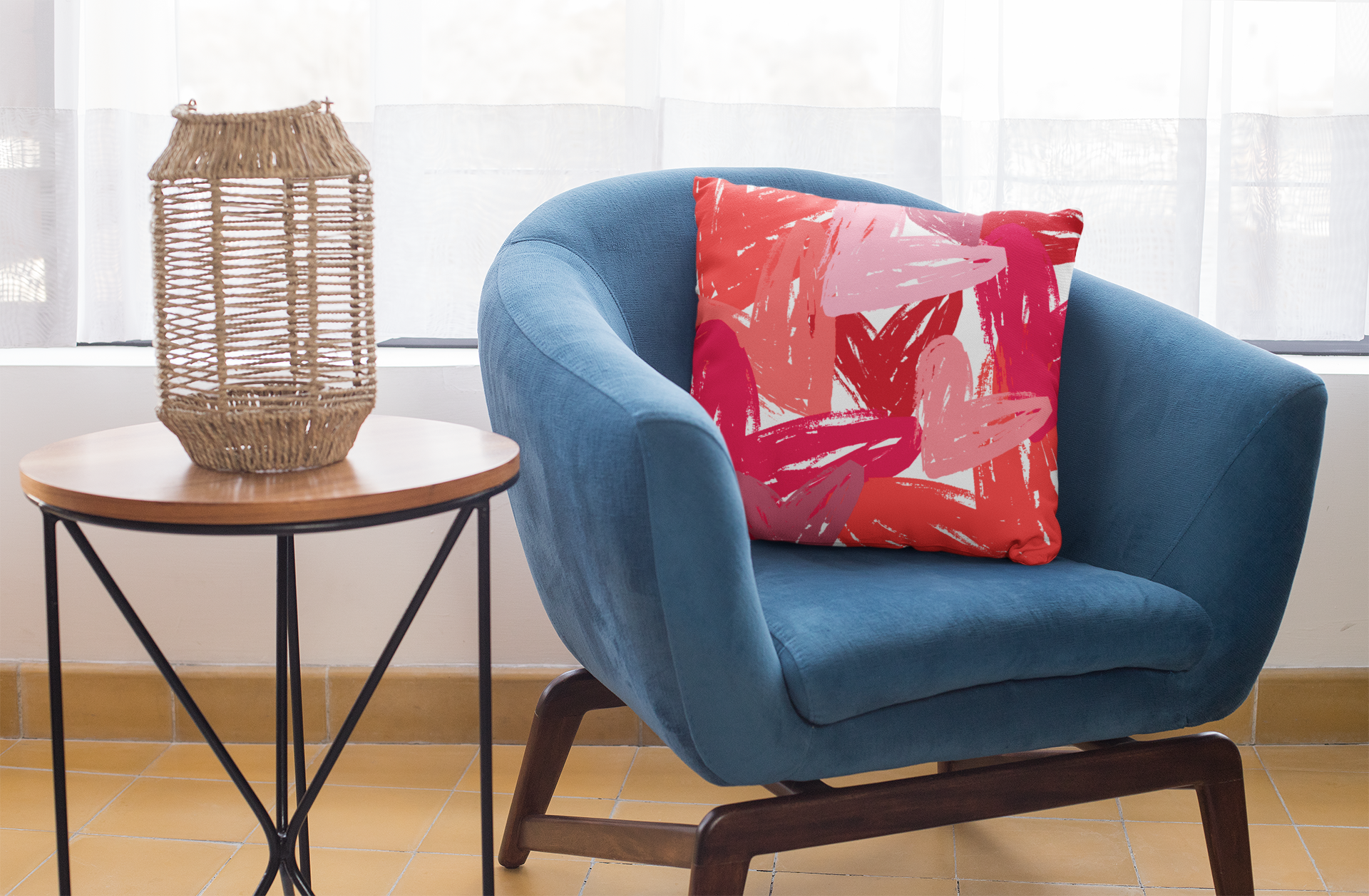 Red and pink heart throw pillow on blue accent chair.